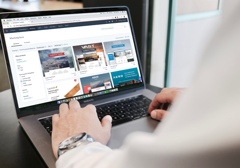 Hands using a laptop with a website open on screen