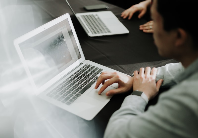 A person working at a laptop in a bright room